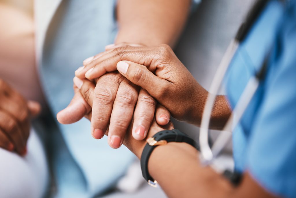 Empathy, trust and nurse holding hands with patient for help, consulting support and healthcare advice. Kindness, counseling and medical therapy in nursing home for hope, consultation and psychology