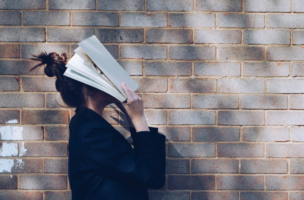 Woman with book in her face/ Mulher com livro no rosto